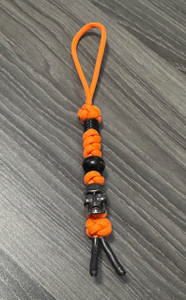 Orange Paracord Knife Lanyard with Black Skull Bead and Spacer Beads Orange Paracord Knife Lanyard with Black Skull Bead and Spacer Beads