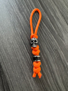 High Visibility Small Orange Knife Lanyard with Skull Bead and Black Carbon Wrap Bead High Visibility Small Orange Knife Lanyard with Skull Bead and Black Carbon Wrap Bead