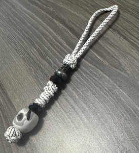 Arctic White Paracord Knife Lanyard with Black Faceted Beads and Marbled Acrylic Camo Bead Arctic White Paracord Knife Lanyard with Black Faceted Beads and Marbled Acrylic Camo Bead