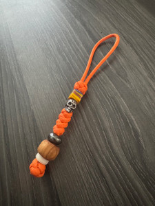 Bright Orange Paracord Knife Lanyard with Blown Glass Bead, Silver Tribal Skull, Dyed Olive Wood, and Blue Night Glow Bead Bright Orange Paracord Knife Lanyard with Blown Glass Bead, Silver Tribal Skull, Dyed Olive Wood, and Blue Night Glow Bead