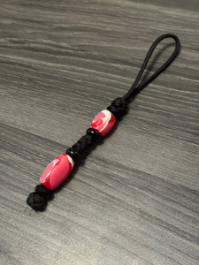 Black Paracord Knife Lanyard with Hand Shaped Pink Acrylic Beads and Black Spacer Bead Accents Black Paracord Knife Lanyard with Hand Shaped Pink Acrylic Beads and Black Spacer Bead Accents
