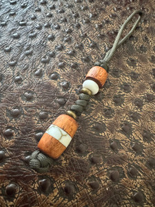 Koa Wood and White/Gold Web Tru-Stone Split Bead Knife Lanyard on OD Green Cordage Koa Wood and White/Gold Web Tru-Stone Split Bead Knife Lanyard on OD Green Cordage