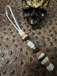 Custom Split Bead Knife Lanyard with Gold Web Tru-Stone, Koa Wood, Ebony, and Brass Spacers on White with Black Spec Paracord Custom Split Bead Knife Lanyard with Gold Web Tru-Stone, Koa Wood, Ebony, and Brass Spacers on White with Black Spec Paracord