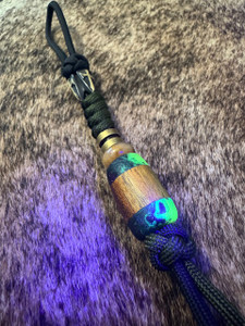 Two-Tone Black and OD Green Paracord lanyard with Glow In The Dark Resin and Koa Split Bead Accented by Metal Shield Cross