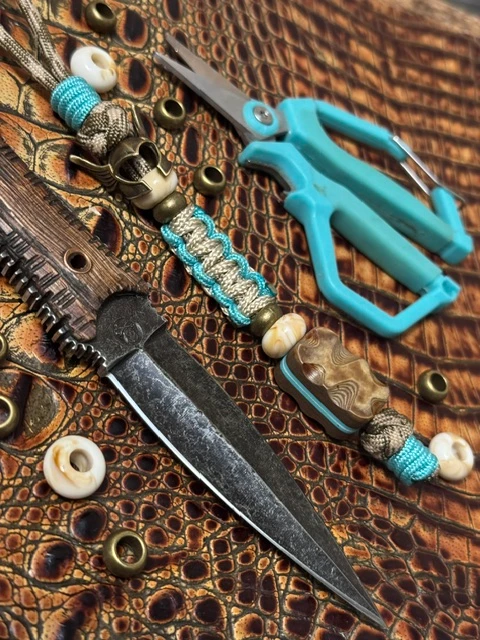Handmade Tang Danglers knife lanyard with a sculpted bead