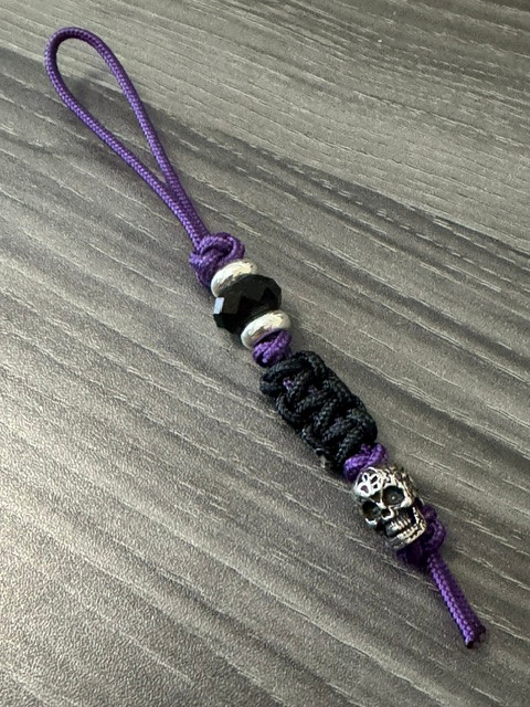 Purple Mini Cord with Black Cobra Wrap and Engraved Stainless Skull Accented by Silver Spacers and Black Faceted Beads