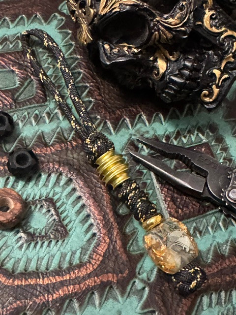 Gold Flake Resin and Shredded Money Resin Knife Nub with Polished Brass Spindle and Spacer on Black/Gold Paracord