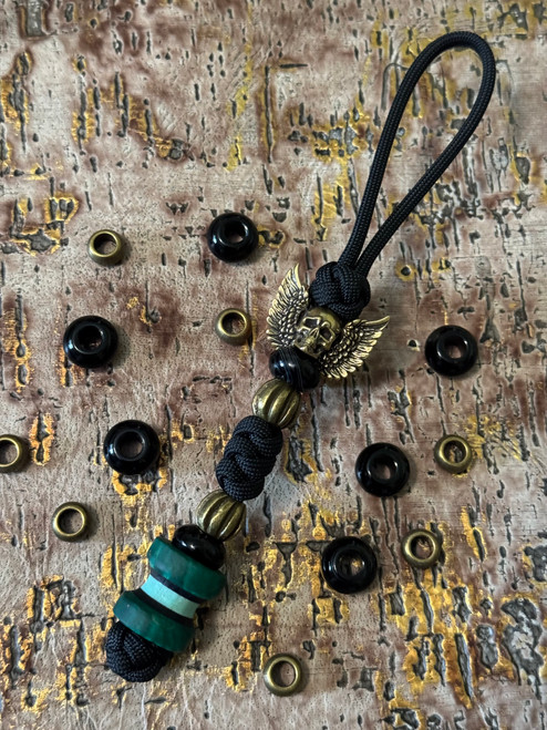 Winged Brass Skull Paracord Lanyard with Dyed Curly Maple, Black G10, and Tiffany Blue G10 Handmade Bead Accented by Onyx and Brass Spacers