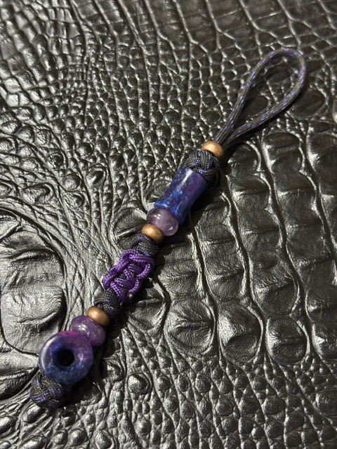 Glow In The Dark Spindle and Infinity Resin Bead Knife Lanyard on Black/Purple Paracord Accented by Purple Cobra Wrap, Amethyst, and Copper Spacers