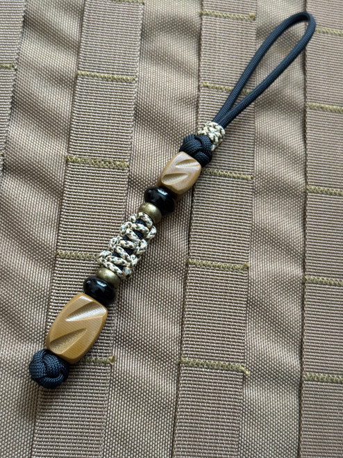 Hand Sculpted Coyote G10 Tactical Series Knife Lanyard on Black 550 Cord with Cobra Mini Cord Wrap, Onyx, and Brass Spacers