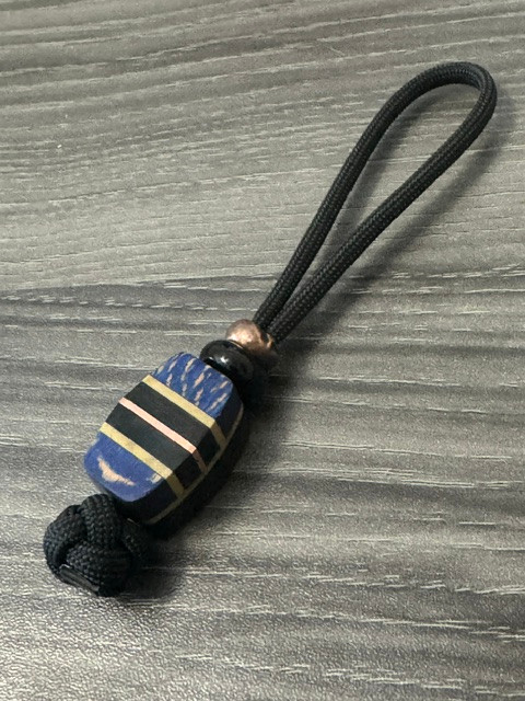 Custom Split Bead Knife Nub with Black Carbon Fiber, Dyed Blue Burl, Tan G10, Black G10, and Copper Accented by Onyx and Copper Spacers On Black 550 Cord