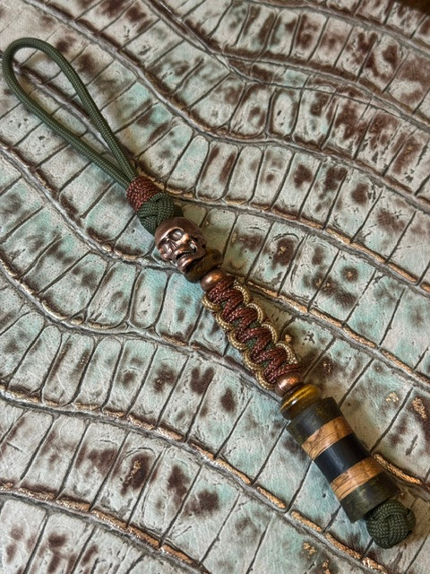 Dyed Green Burl, Whiskey Barrel, and Dark Ironwood Spindle Bead Knife Lanyard on OD Green Paracord with Two-Tone Cobra Wrap, Copper Skull, and Tiger's Eye