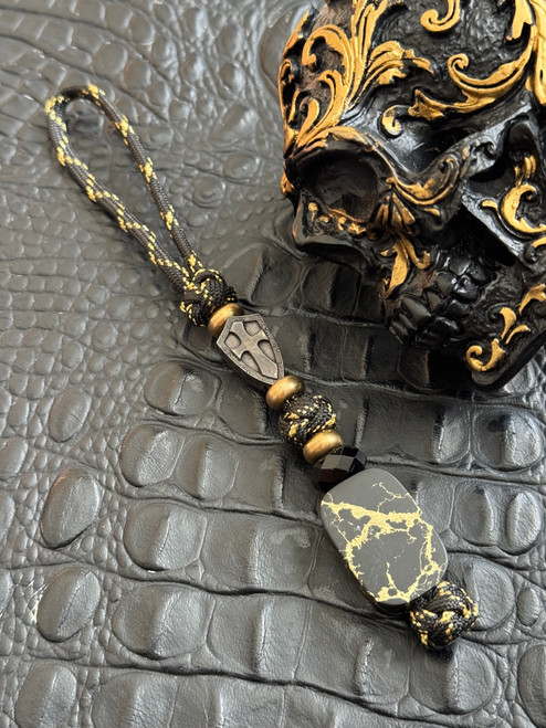 Handmade Black with Gold Web Polished Tru-Stone Bead Knife Lanyard on Black & Gold Paracord with Brass Accents and Hammered Black Shield Cross