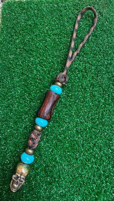 Desert Ironwood Bead Knife Lanyard with Large Brass Skull, Turquoise, and Brass Spacers on Fall Camo Paracord