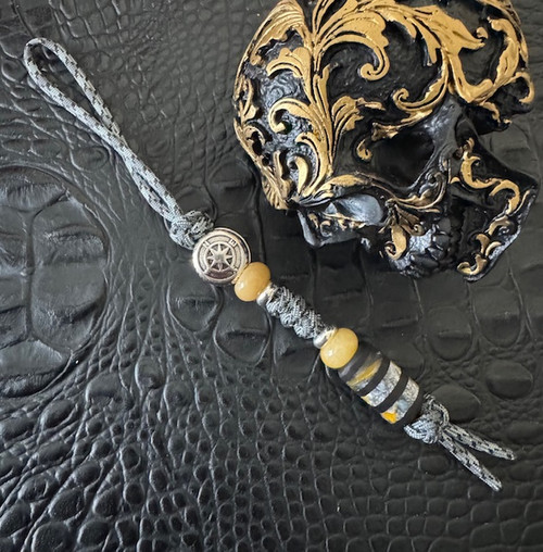 Ebony and Deep Yellow Swirl Resin Split Bead Knife Lanyard with Silver EDC Compass Bead on Black/Gray Paracord