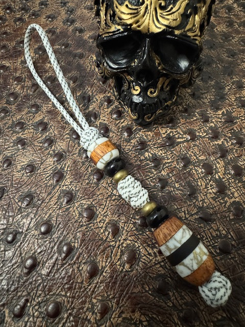 Custom Split Bead Knife Lanyard with Gold Web Tru-Stone, Koa Wood, Ebony, and Brass Spacers on White with Black Spec Paracord