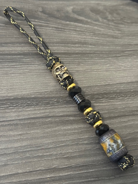 Handmade Yellow, Silver, and Black Swirl Resin Bead Knife Lanyard with Brass Skull and Faceted Black Accents