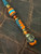 Two-Tone Black Diamond Turquoise & Orange 550 Cord Lanyard with Snakewood, Orange HyperGlow, and Turquoise Split Bead Accented by Polished Brass Reaper