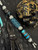 Silver Carbon Fiber, Black G10, and Black Web Turquoise Split Bead Lanyard with Arctic White Paracord, Turquoise & Black Diamond Cobra Wrap, Black Metal Skull, and Turquoise Spacers