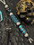 Silver Carbon Fiber, Black G10, and Black Web Turquoise Split Bead Lanyard with Arctic White Paracord, Turquoise & Black Diamond Cobra Wrap, Black Metal Skull, and Turquoise Spacers