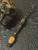 Coffin Collection Gold Flake & Shredded Money Resin Bead On Reactive Black/Gold Cord with Polished Brass Skull and Lava Rock Accents