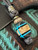 "Knife Scale Bead" Lanyard with Brown Micarta, Tiffany Blue G10, Black G10, and Maple Burl Split Accented by Brass, Picture Jasper, and Mini Cord Wrap