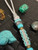 Premium Collection Silver Carbon Fiber & Gold Web Turquoise Tru-Stone Knife Lanyard with Gray and Turquoise Cobra Wrap Accented by Turquoise and Brass