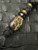 Black 550 Cord Knife Lanyard with Mahogany Wood and Resin Over Carbon Fiber Bead Accented by Black Metal Skull, Faceted Spacers, Brass, and Tan Camo Mini Cord Wrap