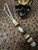 Custom Split Bead Knife Lanyard with Gold Web Tru-Stone, Koa Wood, Ebony, and Brass Spacers on White with Black Spec Paracord