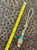 Gold Web Turquoise Tru-Stone and Koa Wood Split Bead Knife Lanyard with Brass Wrapped Feather Bead on Desert Camo Paracord Gold Web Turquoise Tru-Stone and Koa Wood Split Bead Knife Lanyard with Brass Wrapped Feather Bead on Desert Camo Paracord