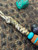 Gold Web Turquoise Tru-Stone and Koa Wood Split Bead Knife Lanyard with Brass Wrapped Feather Bead on Desert Camo Paracord Gold Web Turquoise Tru-Stone and Koa Wood Split Bead Knife Lanyard with Brass Wrapped Feather Bead on Desert Camo Paracord