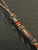 Brass Samurai Mask Knife Lanyard with Snakewood and Gold Web Tru-Stone Beads Accented by Red Carnelian and Brass Spacers Brass Samurai Mask Knife Lanyard with Snakewood and Gold Web Tru-Stone Beads Accented by Red Carnelian and Brass Spacers