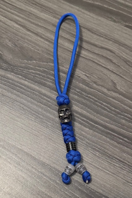 Royal Blue Paracord Knife Lanyard with Black Skull Bead and Glow In The Dark Mini Skulls