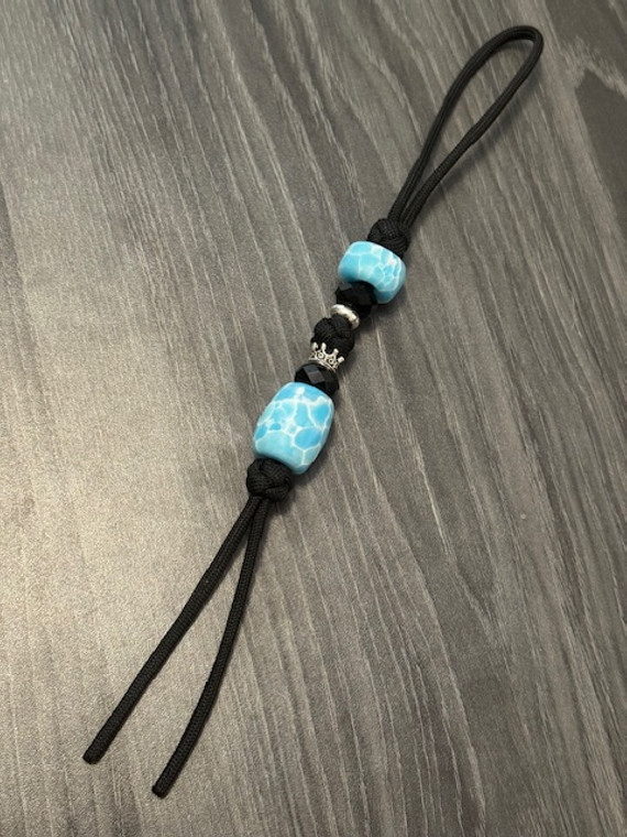 TruStone Collection Handmade Larimar Blue Bead Knife Lanyard on Black Paracord with Faceted Black and Silver Crown Accents TruStone Collection Handmade Larimar Blue Bead Knife Lanyard on Black Paracord with Faceted Black and Silver Crown Accents