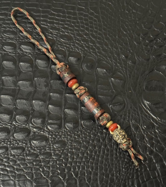 Brass Samurai Mask Knife Lanyard with Snakewood and Gold Web Tru-Stone Beads Accented by Red Carnelian and Brass Spacers Brass Samurai Mask Knife Lanyard with Snakewood and Gold Web Tru-Stone Beads Accented by Red Carnelian and Brass Spacers