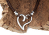 Sterling silver open-work heart pendant on brown Portuguese cork cord with silver bead accents displayed on driftwood — Crabby Mermaid