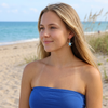 Woman wearing Larimar turtle dangle earring on a Florida beach — genuine Dominican Republic Larimar — Crabby Mermaid