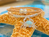 Close-up of genuine Larimar crab pendant on natural Portuguese cork cord with silver ball clasp — handcrafted coastal jewelry