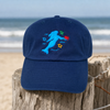 Crabby Mermaid original hat in navy displayed on driftwood at the beach — Crabby Mermaid