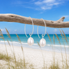 Pearl marquise sterling silver earrings with freshwater pearl hanging from driftwood on Florida Gulf Coast beach - Crabby Mermaid