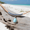 Larimar teardrop necklace on cork cord with sterling silver accent displayed on driftwood — Florida artisan jewelry — Crabby Mermaid