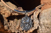 Sterling silver mermaid medallion cork necklace with large tube accent displayed on driftwood — side angle — Crabby Mermaid