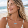 Close-up of woman wearing Larimar bar necklace on a Florida beach — genuine Dominican Republic Larimar — Crabby Mermaid
