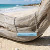 Larimar bar necklace hanging from driftwood on the beach - genuine Dominican Republic Larimar - Crabby Mermaid
