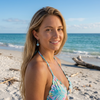 Woman wearing Larimar square drop earring in sterling silver on a Florida beach
