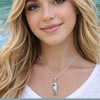 Larimar seahorse necklace worn on model at beach — genuine Dominican Republic Larimar hand assembled by Crabby Mermaid