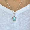 Larimar sea turtle necklace worn on model showing pendant size on white top — genuine Dominican Republic Larimar