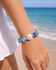 Silver sand dollar sea glass stretch bracelet worn on wrist — beach jewelry — Crabby Mermaid