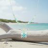 Silver-toned ombre sea turtle beaded necklace on beach sand with coastal styling - coastal jewelry - Crabby Mermaid