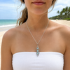 Close up of Larimar three sea turtle marquise pendant necklace in sterling silver worn on model at Florida beach - genuine Dominican Republic Larimar - Crabby Mermaid